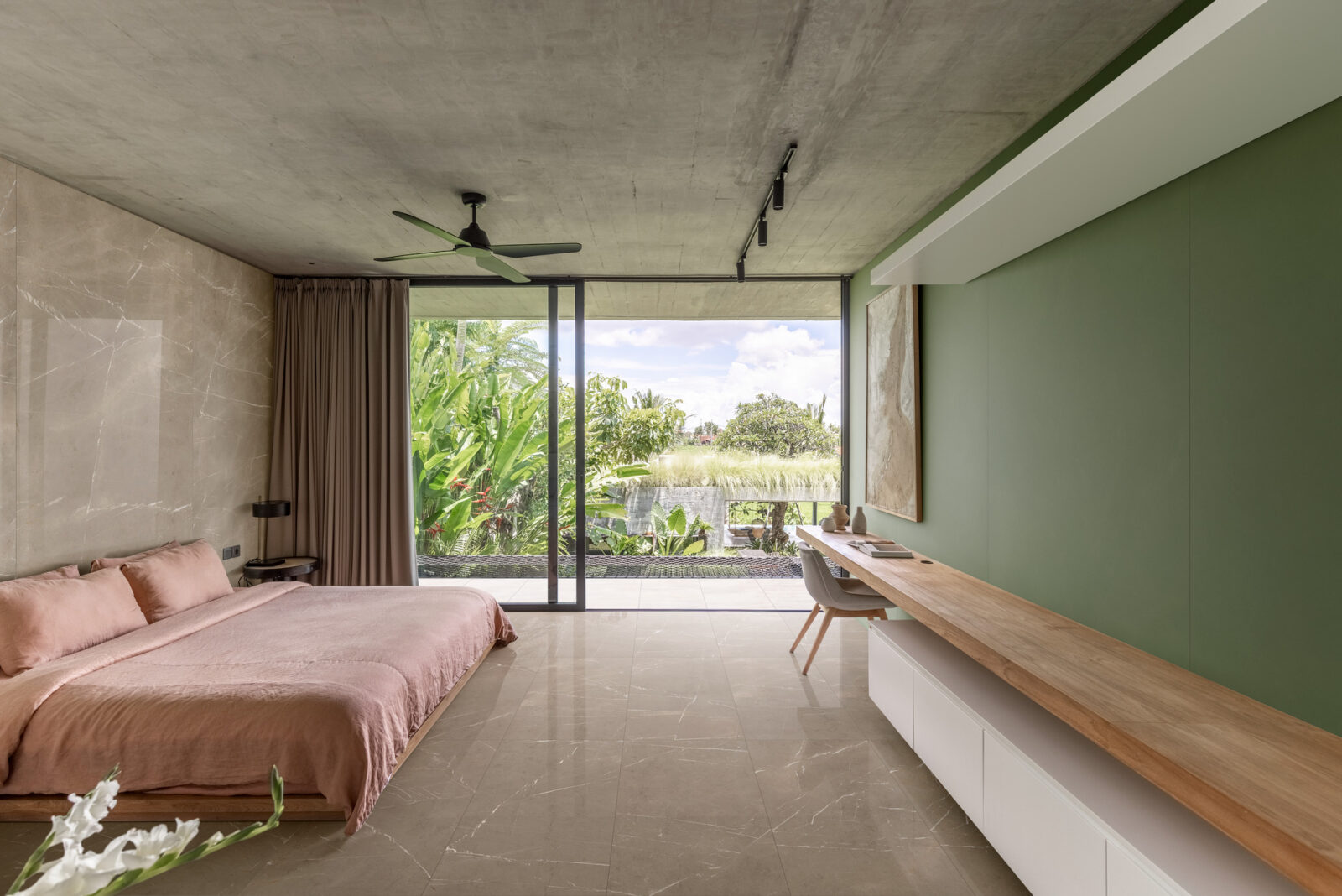 Travertine look tiles in a tropical bedroom